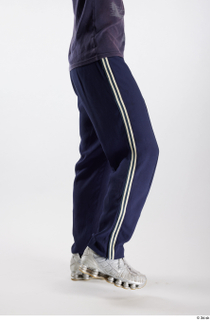 Urien  1 blue track pants dressed flexing leg side…